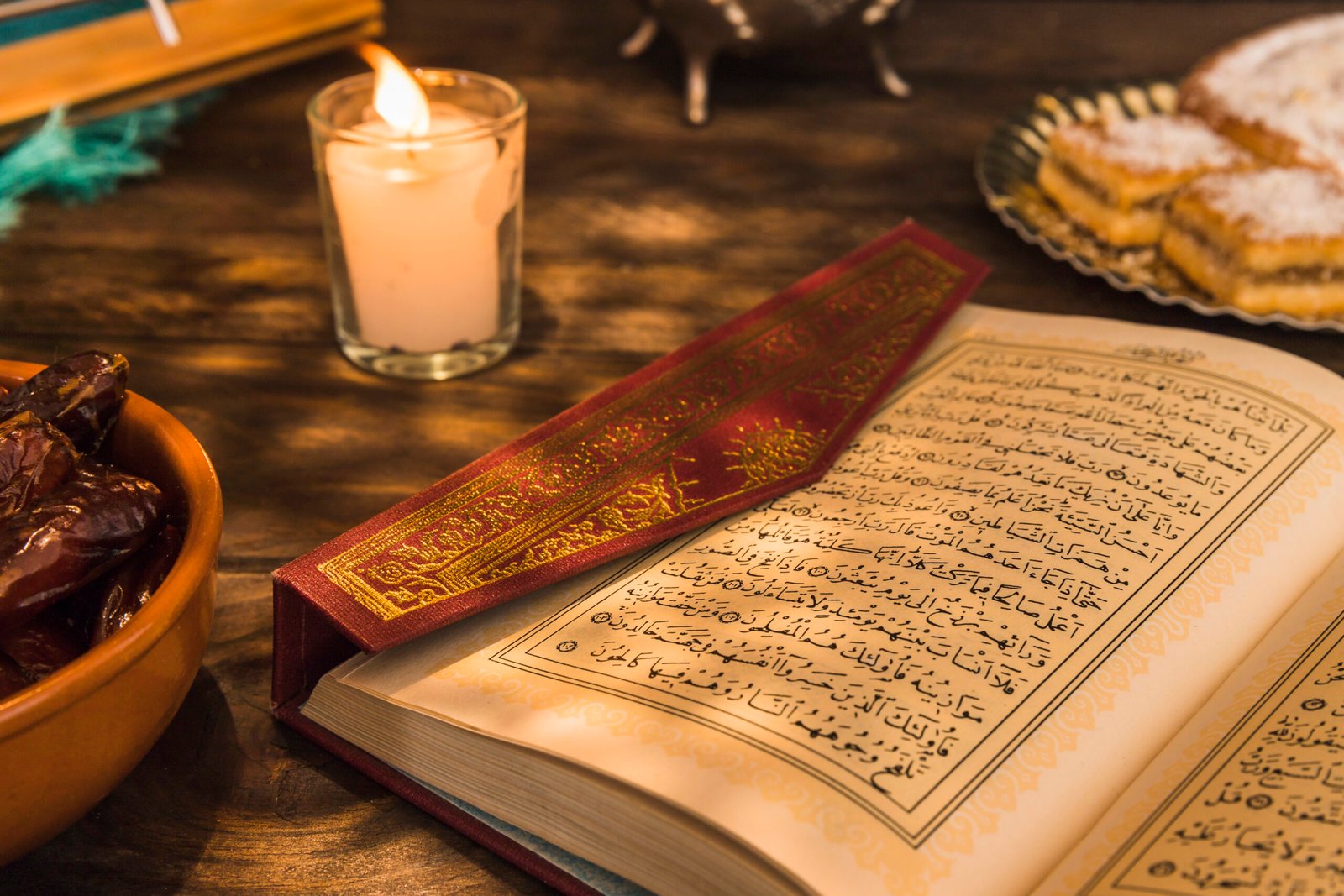 opened-quran-near-candle-sweet-dates